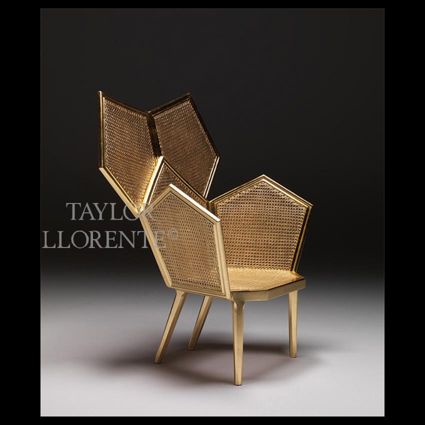 designer armchair with gold leaf wicker frame