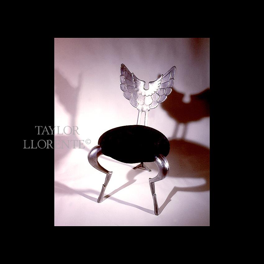 chair in sculptural cast metal wing design backrest